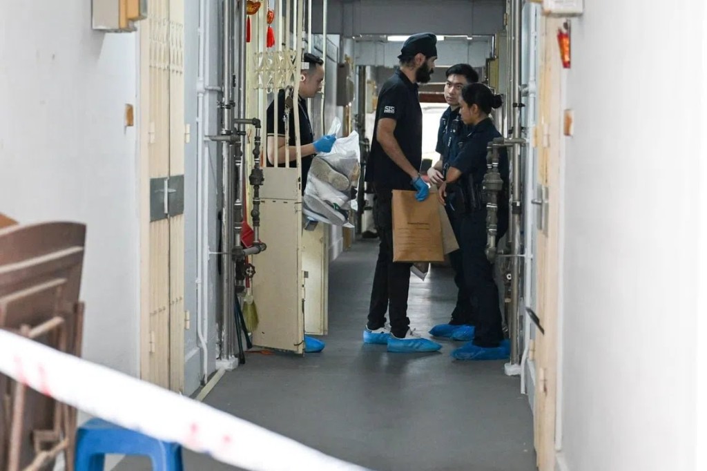 Investigators collecting evidence at a cordoned residential corridor